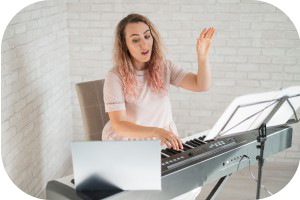Image of a smiling female vocal tutor at a piano